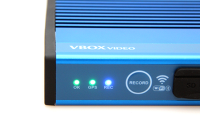 Photograph of the LEDs on the front panel of VBOX Video HD2. OK and GPS are illuminated green and the REC LED is illuminated blue.