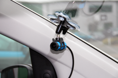 Photograph of the second RLACS222 camera mounted to the corner of the windscreen using a suction mount.