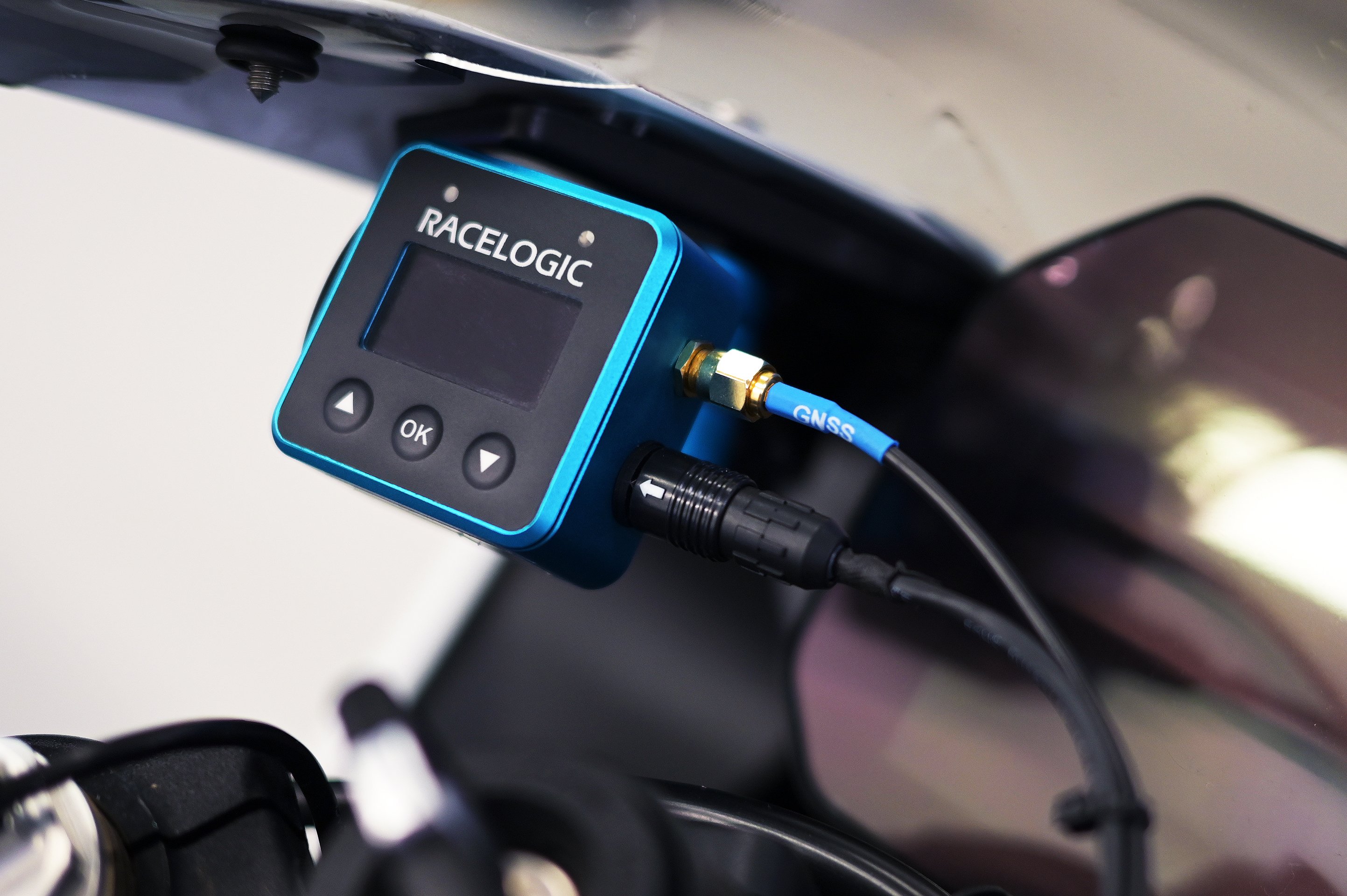 Example installation of a VBOX Mini LapTimer unit mounted on a motorcycle with the GNSS antenna cable and power connection attached.