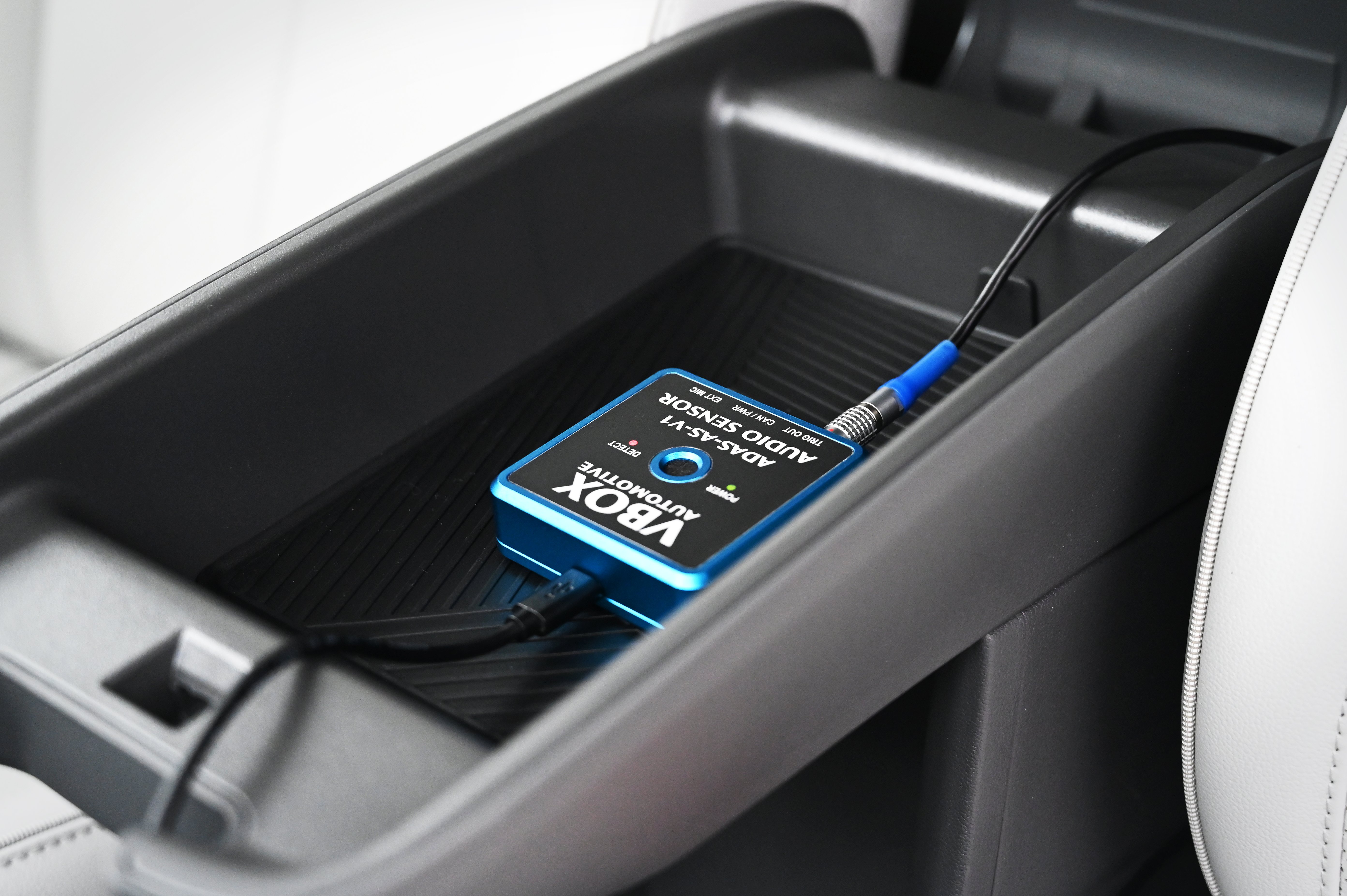 Photograph of the ADAS Audio Sensor in a vehicle connected via the USB and TRIG OUT ports.