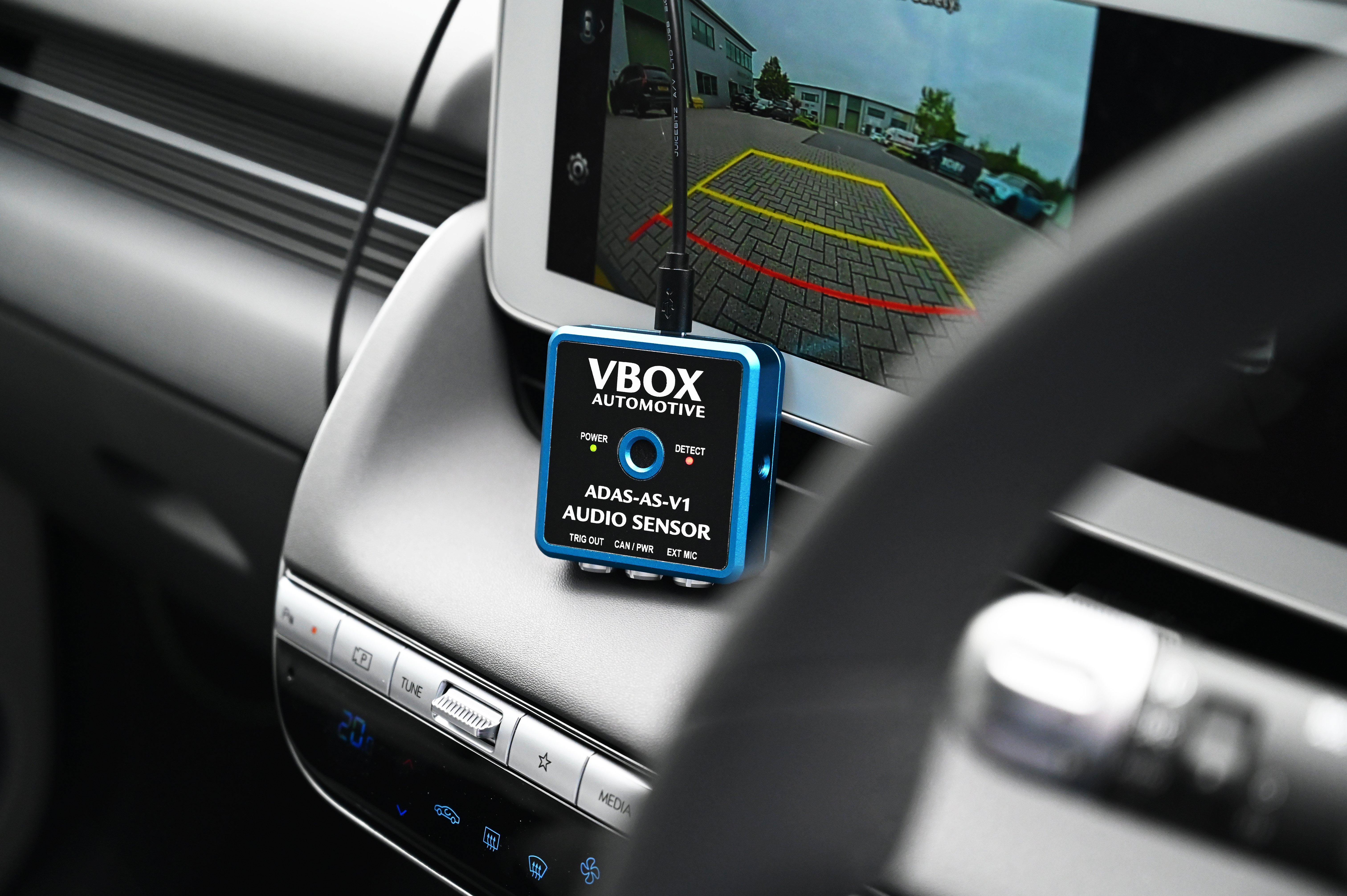 Photograph of the ADAS Audio Sensor in a vehicle with USB connected.
