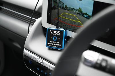 Photograph of the ADAS Audio Sensor in a vehicle with USB connected.