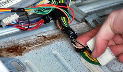 Close up photograph of finding the RPM wire in a Mazda MX-5.
