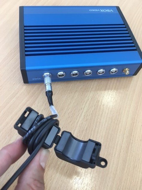 Photograph of the power cable wrapped around the ferrite choke, with the choke open.