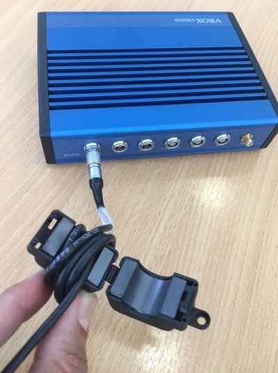 Photograph of the power cable wrapped around the ferrite choke, with the choke open.