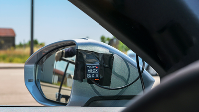 Photograph of ADAS Visual Sensor in place on the wing mirror of a vehicle with the red LED illuminated