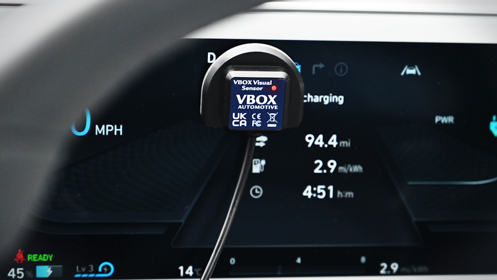 Photograph of ADAS Visual Sensor in place on the dashboard of a vehicle with the red LED illuminated