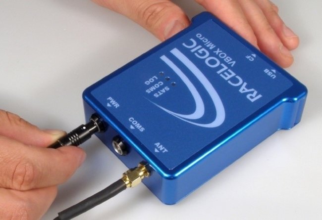 Photograph of a hand connecting power to VBOX Micro