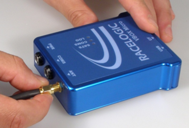 Photograph of a hand connecting the antenna to VBOX Micro