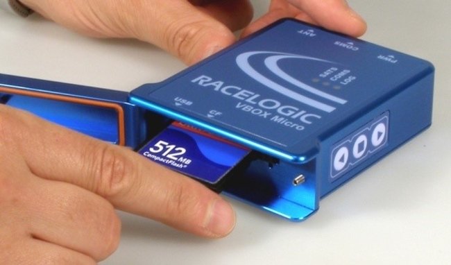 Photograph of a hand inserting a compact flash card into VBOX Micro