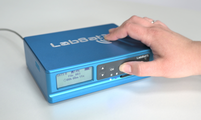 Photograph of a hand pressing the REC button on a LabSat 4.