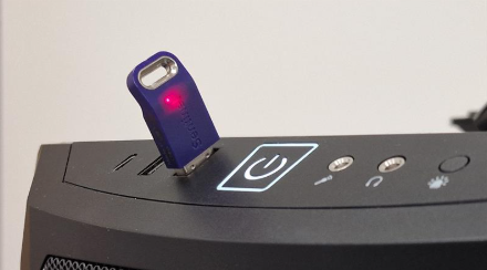Photograph of a SatGen dongle inserted into a PC.