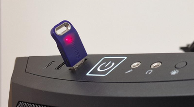 Photograph of a SatGen dongle inserted into a PC.