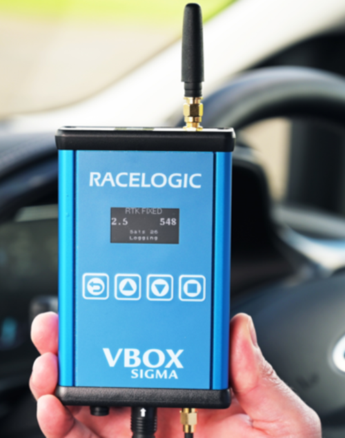 Photograph of a hand holding a VBOX Sigma.