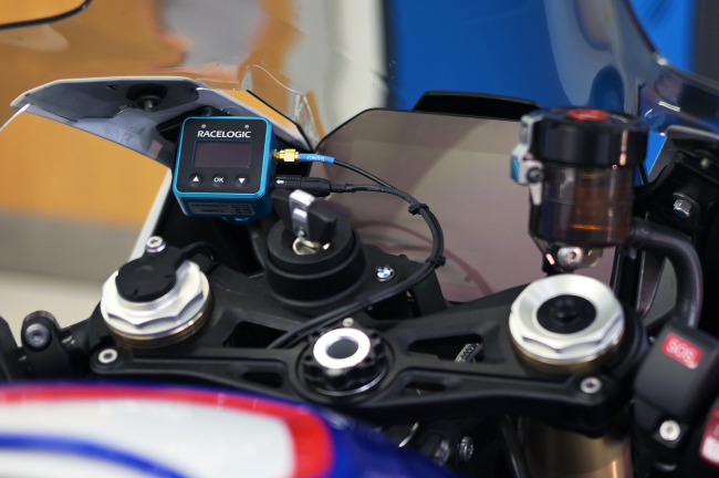 Example installation of a VBOX Mini LapTimer unit mounted on a motorcycle with the GNSS antenna cable and power connection attached.
